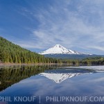 Reflection of Mt. Hood in Trillium Lake in Spring under a brilliant blue sky.